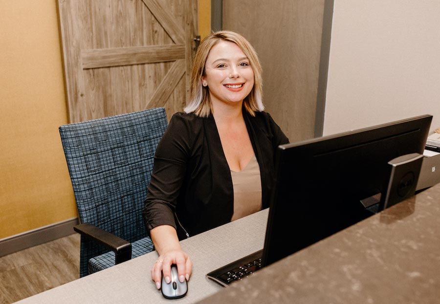 woman sitting at reception desk