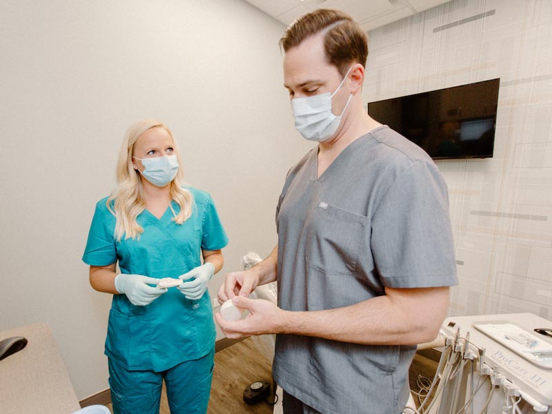 two dental professionals talking