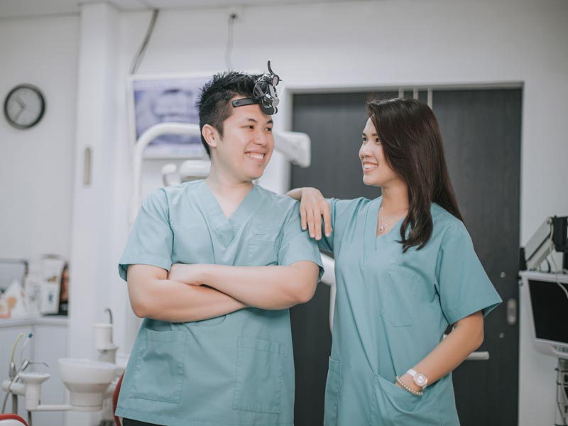 two dental professionals smiling