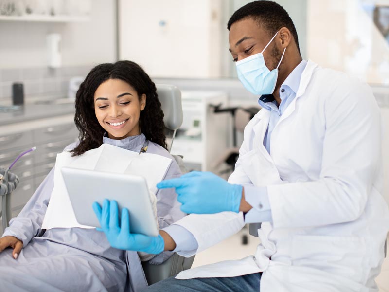 dentist showing something to patient