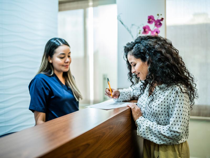 patient filling out forms at reception